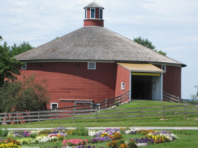 exterior space with a barn and fence