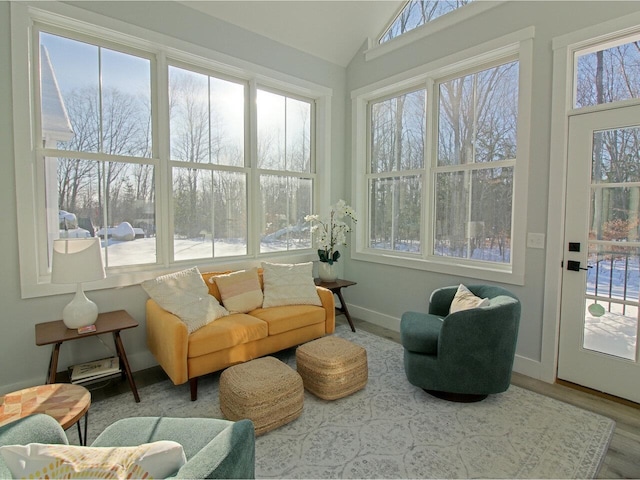 sunroom featuring plenty of natural light and vaulted ceiling