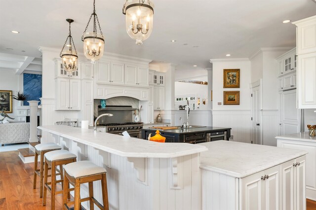 kitchen with white cabinetry, a large island, and glass insert cabinets