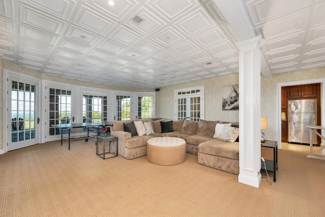 living room with an ornate ceiling, light colored carpet, and wallpapered walls