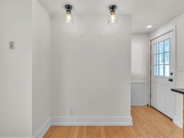 interior space featuring light wood-type flooring and baseboards