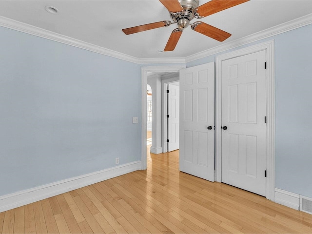 unfurnished bedroom with light wood finished floors, a closet, ornamental molding, ceiling fan, and baseboards