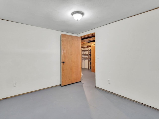 unfurnished room featuring finished concrete floors