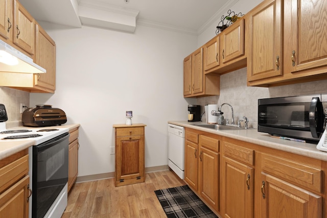 kitchen with under cabinet range hood, white appliances, a sink, light countertops, and ornamental molding