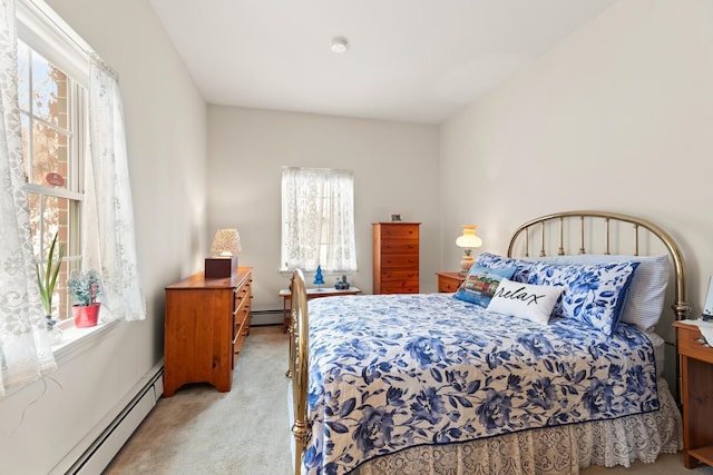 bedroom featuring light carpet and a baseboard heating unit