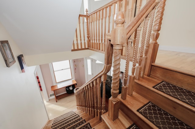 stairs featuring baseboards and wood finished floors