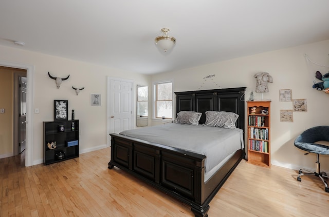 bedroom featuring light wood-type flooring and baseboards