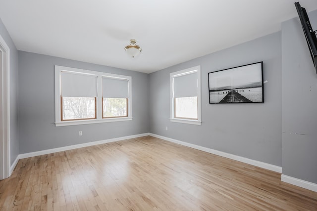 empty room featuring light wood-style floors and baseboards