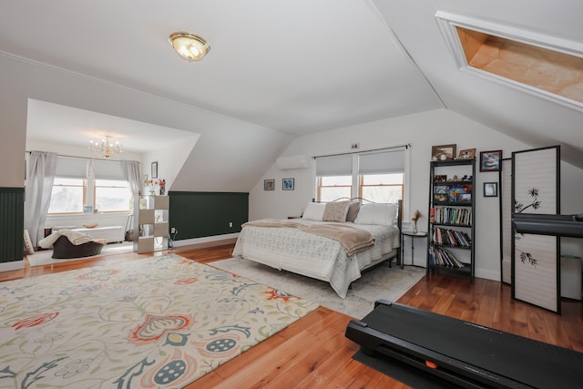 bedroom with multiple windows and wood finished floors