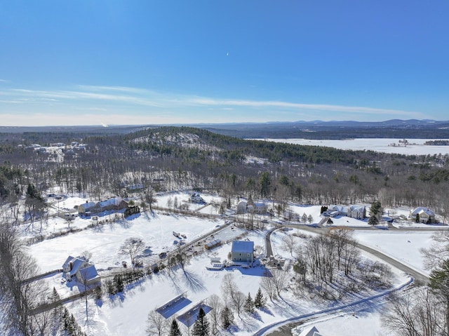 snowy aerial view with a mountain view