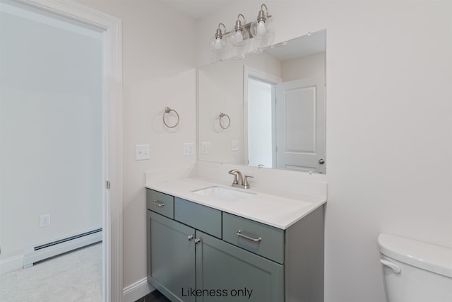 bathroom with toilet, a baseboard radiator, vanity, and baseboards