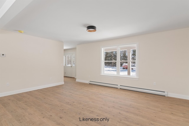 empty room with light wood-style floors, a baseboard radiator, and baseboards