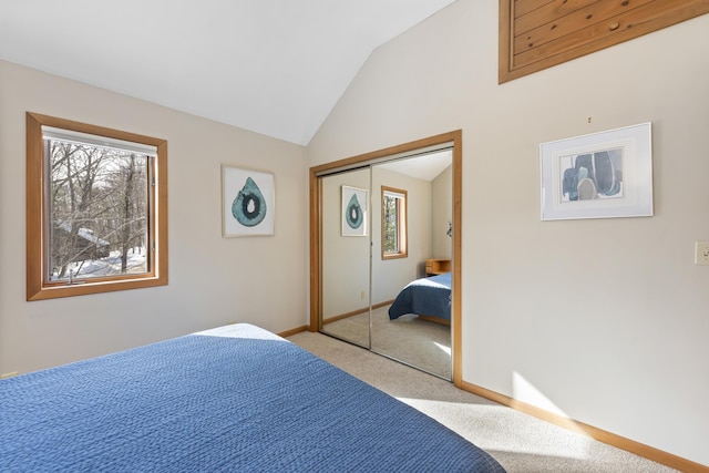 bedroom with light colored carpet, a closet, multiple windows, and lofted ceiling