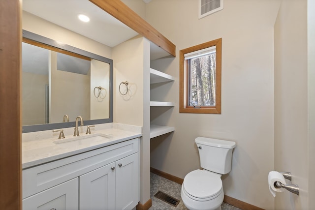 bathroom with visible vents, toilet, vanity, and baseboards