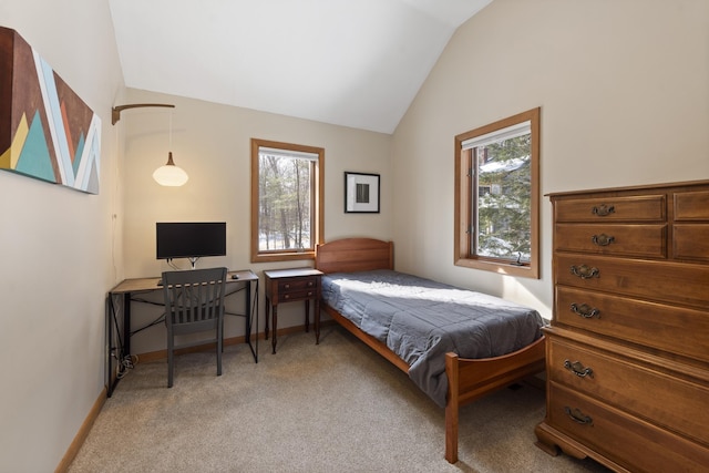 bedroom with light carpet, vaulted ceiling, baseboards, and multiple windows