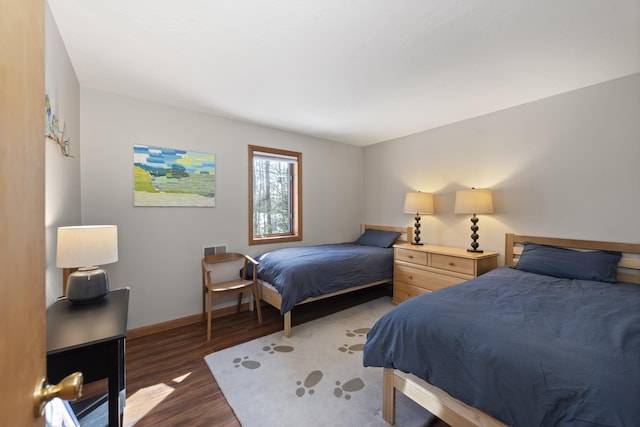 bedroom with dark wood-type flooring, visible vents, and baseboards