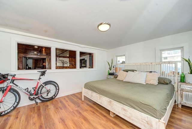 bedroom featuring wood finished floors and baseboards