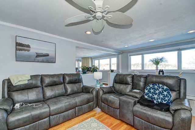 living area with ceiling fan, wood finished floors, crown molding, a baseboard heating unit, and recessed lighting