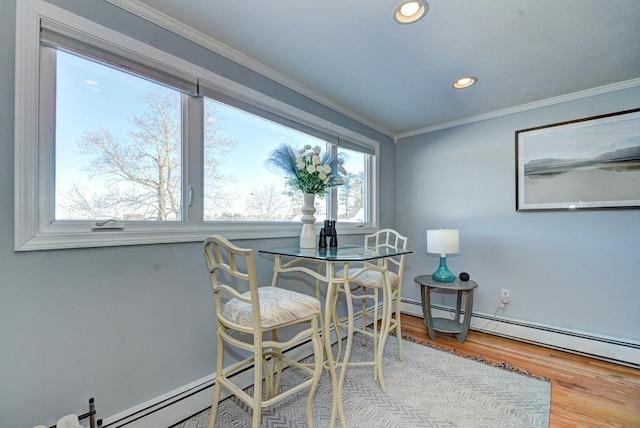 dining space featuring ornamental molding, recessed lighting, and wood finished floors