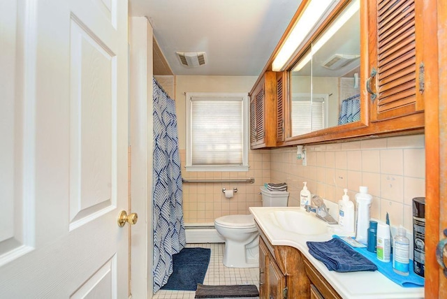 full bathroom featuring tile walls, visible vents, toilet, vanity, and tile patterned flooring