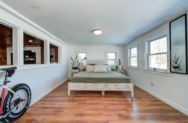 bedroom with baseboards and wood finished floors