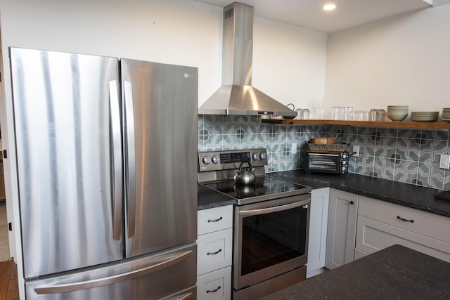 kitchen featuring white cabinets, tasteful backsplash, appliances with stainless steel finishes, and extractor fan