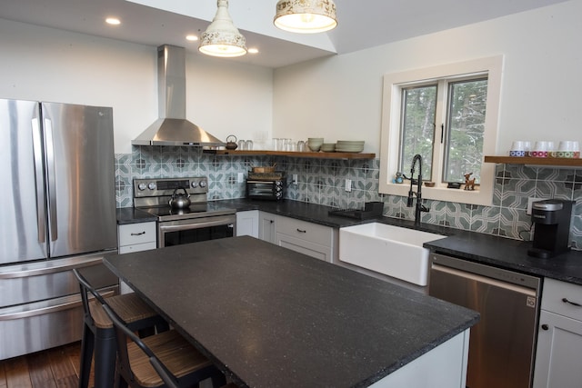 kitchen featuring open shelves, dark countertops, appliances with stainless steel finishes, white cabinets, and wall chimney exhaust hood