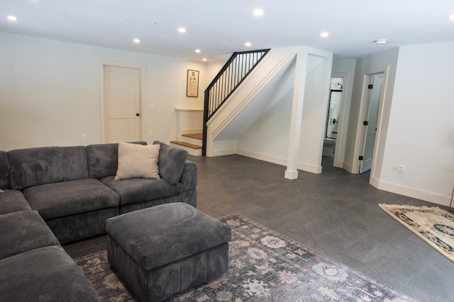 living area featuring baseboards, stairway, and recessed lighting