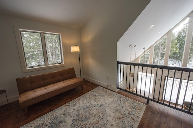 living area featuring baseboards and wood finished floors