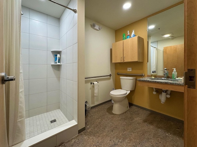 full bathroom with a stall shower, baseboards, a sink, and toilet