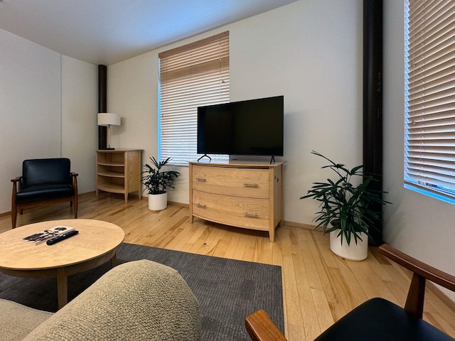 living room with light wood-type flooring and baseboards