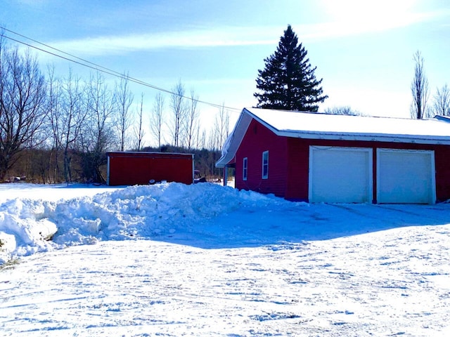 exterior space featuring a garage and an outdoor structure