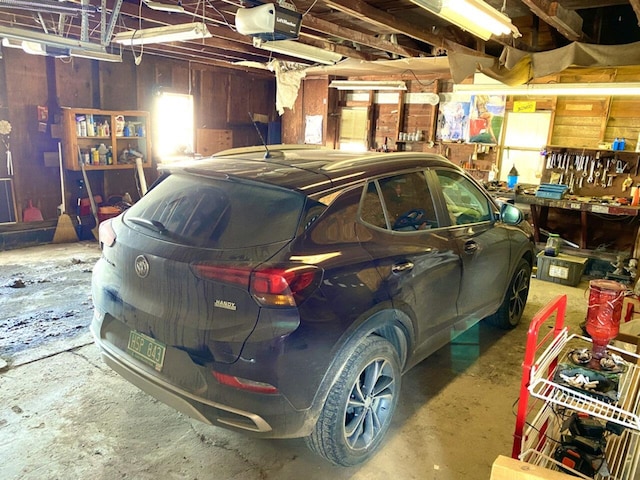 garage with a garage door opener and a workshop area