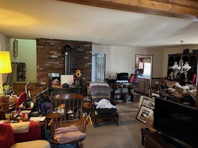 living area featuring a chandelier and a wood stove