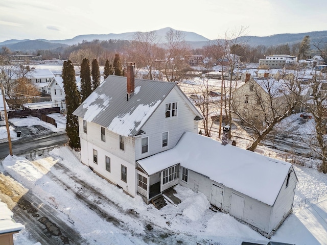 snowy aerial view with a mountain view