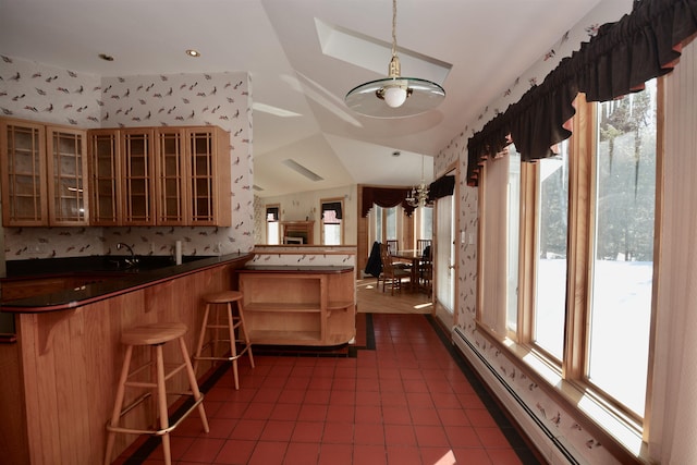 bar with a baseboard heating unit, dark tile patterned floors, decorative light fixtures, and wallpapered walls