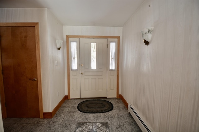 entryway featuring a baseboard heating unit, baseboards, and tile patterned floors