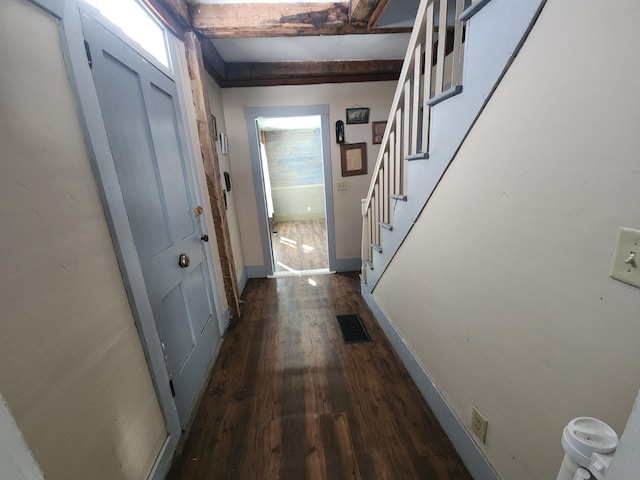 entryway with dark wood-style floors, beam ceiling, visible vents, stairway, and baseboards