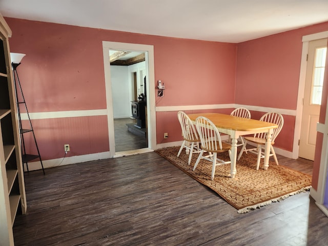 dining room featuring dark wood-type flooring and wainscoting