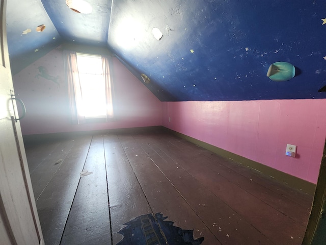 additional living space with lofted ceiling and dark wood-style flooring