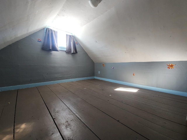 additional living space with lofted ceiling, wood finished floors, and baseboards