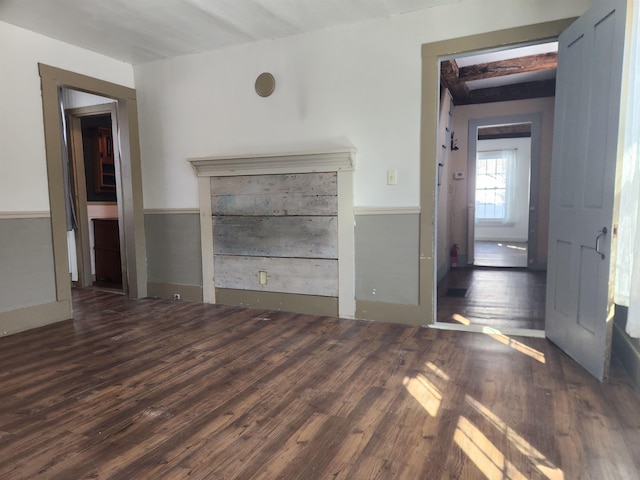 unfurnished living room with dark wood-style flooring