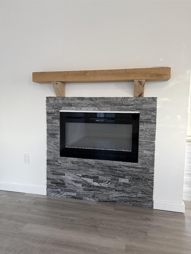 interior details featuring baseboards and wood finished floors