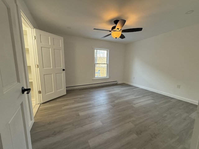 unfurnished bedroom featuring light wood-type flooring, a baseboard radiator, baseboards, and ceiling fan