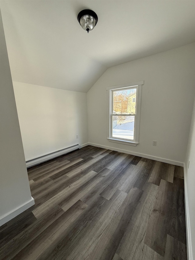 additional living space featuring a baseboard radiator, baseboards, vaulted ceiling, and dark wood-type flooring