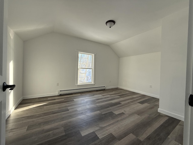 bonus room with a baseboard heating unit, dark wood-type flooring, vaulted ceiling, and baseboards