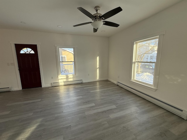 entrance foyer with light wood-style floors, baseboards, and baseboard heating