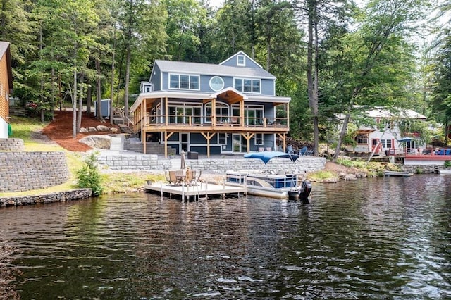 rear view of house featuring a water view