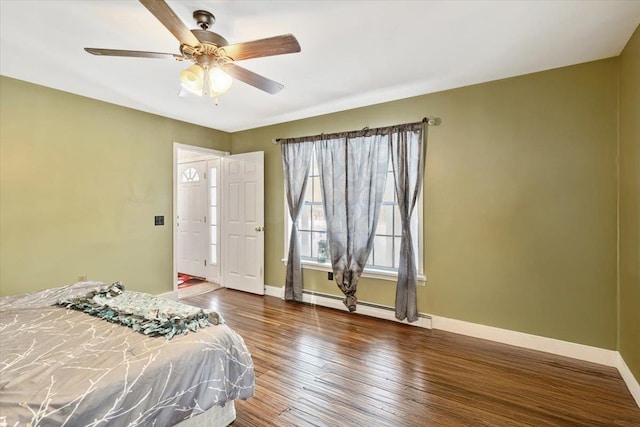 bedroom featuring ceiling fan, dark wood-style flooring, a baseboard radiator, and baseboards