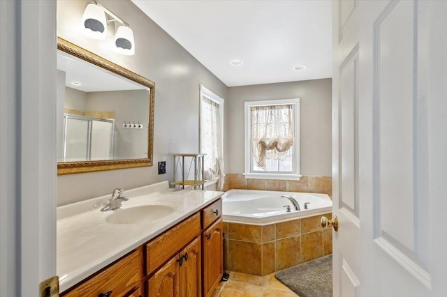 full bath with tile patterned floors, a garden tub, vanity, and a shower stall